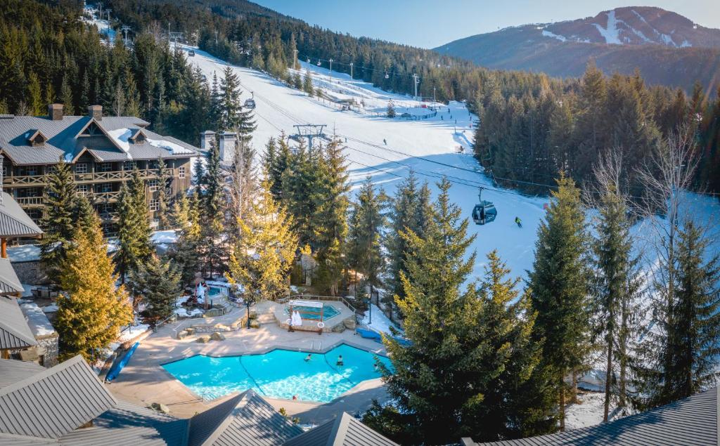 Exterior pool area of Blackcomb Springs in the winter next to the Blackcomb Mountain